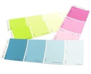 Paint swatches in pink, green, and blue hues are laid out.