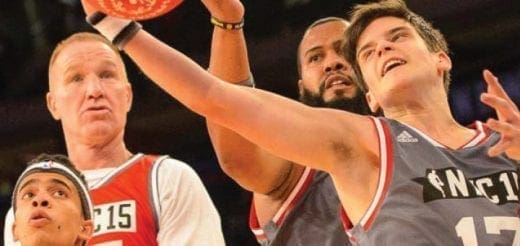 Four men playing basketball during a game.