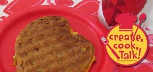 Heart-shaped grilled waffle sandwich on a red plate with a "create, cook, Talk!" logo.