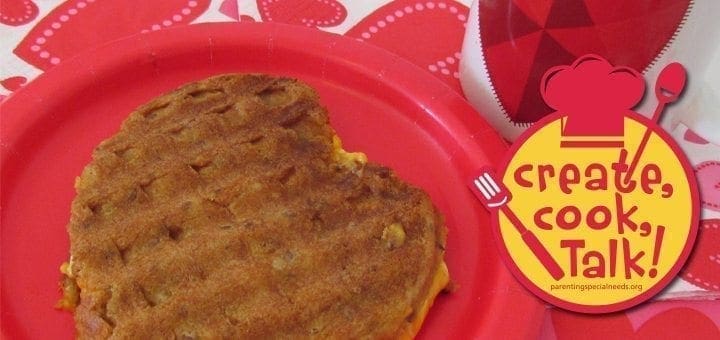 Heart-shaped grilled waffle sandwich on a red plate with a "create, cook, Talk!" logo.