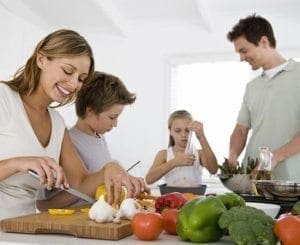 Family preparing a healthy meal together in the kitchen.