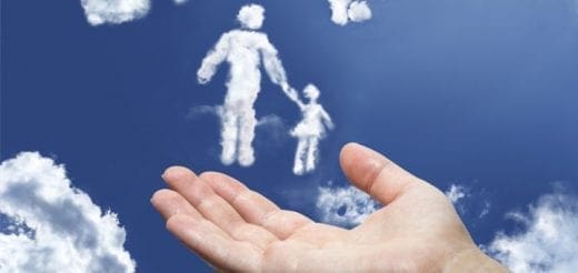 Hand holding clouds shaped like a parent and child in a blue sky.