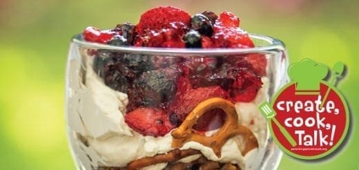 Festive pretzel salad with fruit and cream in a glass.