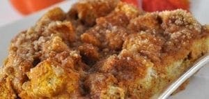 Slice of pumpkin french toast bake on a white plate