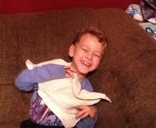DJ Heather smiling with eyes closed while holding a white cloth.
