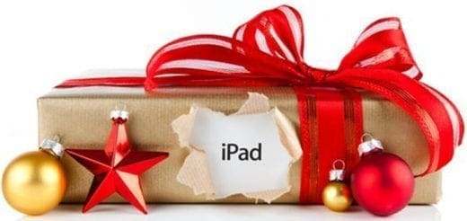 A holiday gift-wrapped iPad with red ribbon and ornaments.