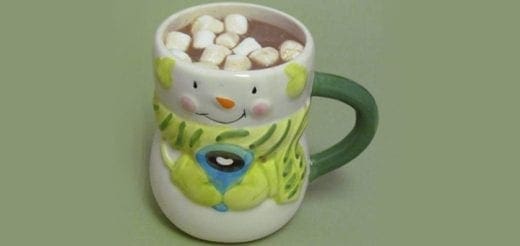 Snowman mug filled with hot cocoa and marshmallows.
