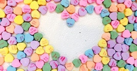 Conversation hearts arranged in a heart shape.