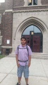 Adnan Shamsi standing in front of a building entrance.