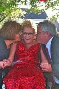 April Gray between two adults.
