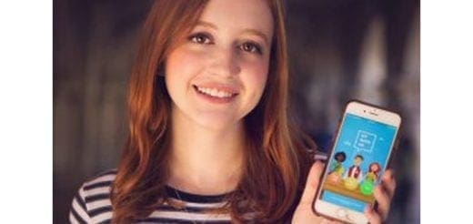 Natalie Hampton holding a phone displaying the 'Sit With Us' app.