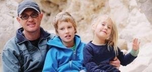 Parent with two children on an outdoor adventure.