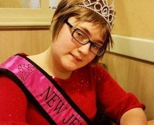 Lily wearing a crown and a "New Jersey" sash.