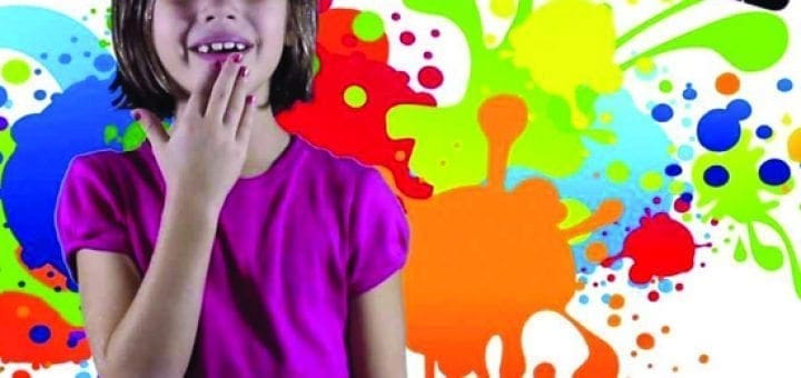 A young girl smiles in front of a colorful paint splatter background with the word "COLORS" at the top.