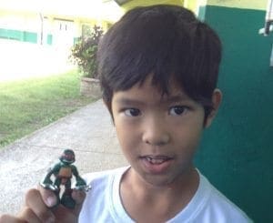 Leandro holds a Teenage Mutant Ninja Turtle action figure.