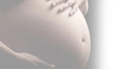 Pregnant belly with hands resting on it