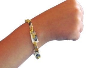A bracelet made of paper clips on a person's wrist.