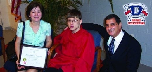 Tony Mancuso with a woman holding a certificate and a young person.