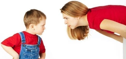 Woman and child facing each other with serious expressions.