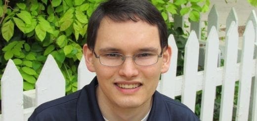 Joshua Walker smiling outdoors.