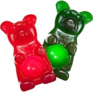Two gummy bears, one red and one green, on a white background.