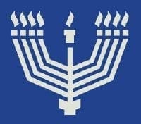 White menorah with lit candles on a blue background.