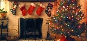 Fireplace with stockings and a decorated Christmas tree.