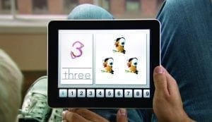 Tablet displaying the number three with three cartoon birds.
