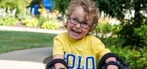 Benjamin smiling in a yellow polo shirt.