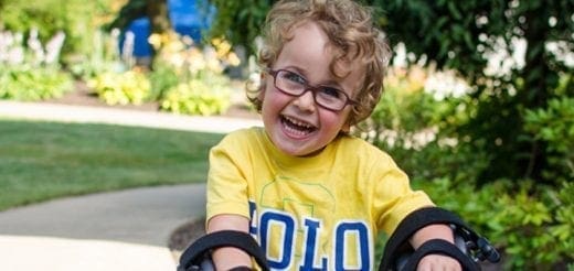 Benjamin smiling in a yellow polo shirt.