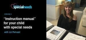 Liz Petruzzi smiling by a table with binders.