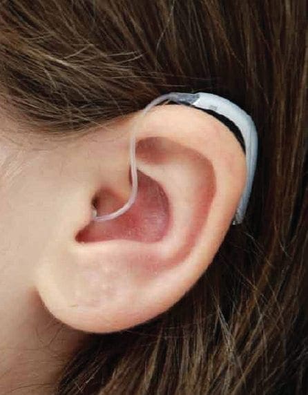 Close-up of a person's ear with a hearing aid.