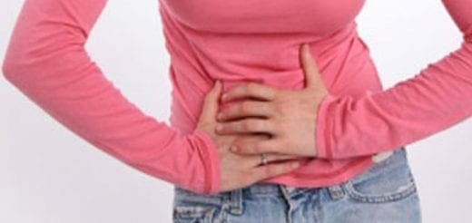 Person holding their abdomen to represent physical discomfort from food.