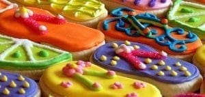 Colorful iced cookies decorated to look like flip-flops and lime slices.