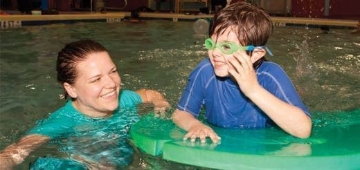 A woman and a child in a swimming pool.
