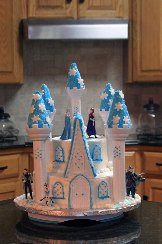 Elsa castle cake with figurines.