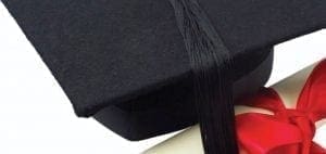 Graduation cap and diploma with a red ribbon