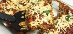Gluten and dairy free lasagna in a baking dish, with a slice being served.