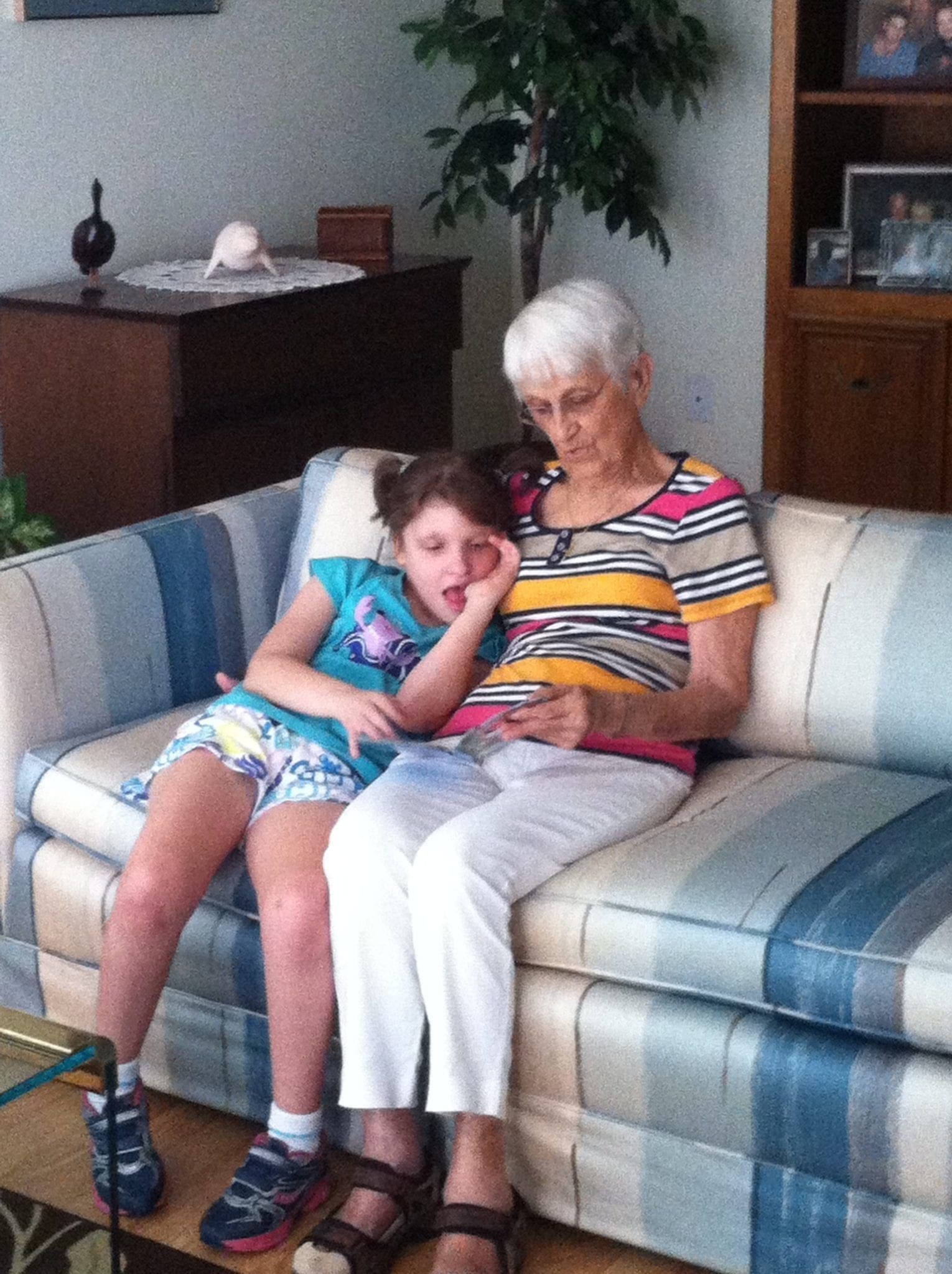 Geri Booth and Taylor sitting on a couch.