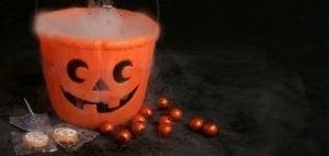 Halloween candy bucket with candy and wrapped sweets