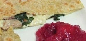 Turkey quesadilla with a side of cranberry-apple sauce.