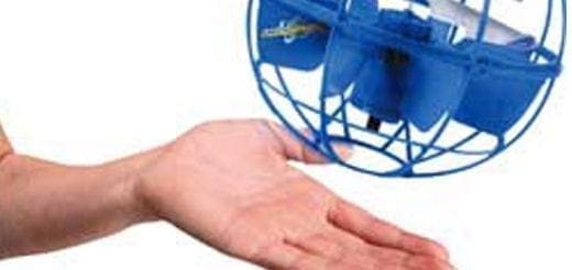 A blue flying ball toy hovers above an open hand.