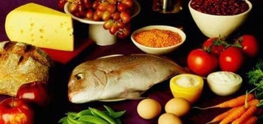 Assortment of healthy foods including cheese, bread, fish, eggs, fruits, and vegetables.