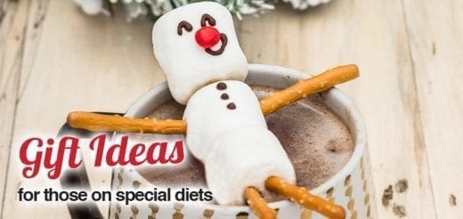 Marshmallow snowman with pretzel arms in a mug of hot chocolate