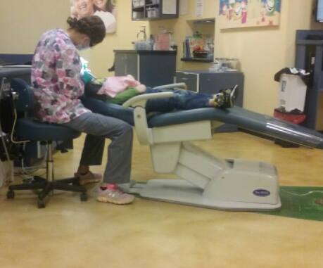Dentist and patient in a dental chair.