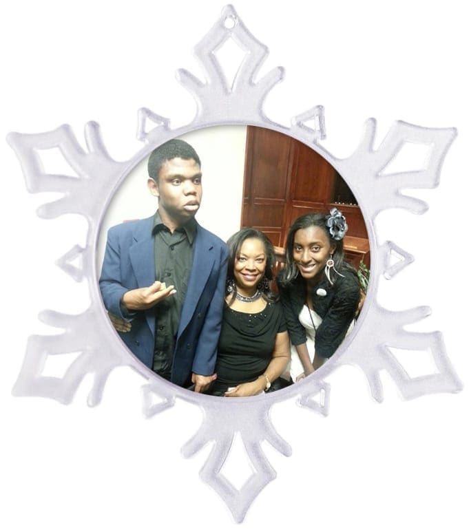 Snowflake ornament with three people inside.