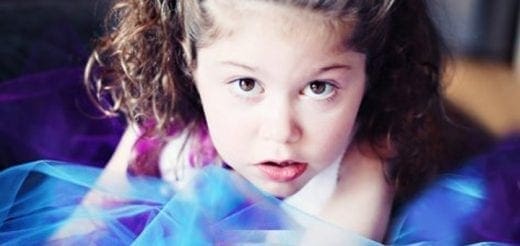 Emily with curly hair and a purple and blue overlay.