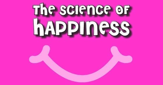 The science of happiness text on a pink background with a smiley face.
