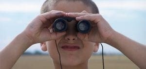 Child looking through binoculars