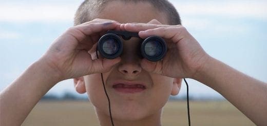 Child looking through binoculars